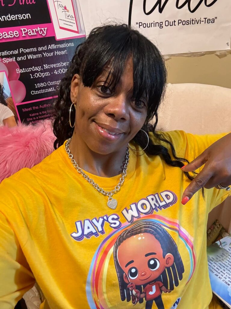 Author Katina Anderson wearing her yellow Jay's World shirt